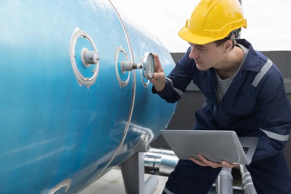 Technician inspecting a diesel storage tank